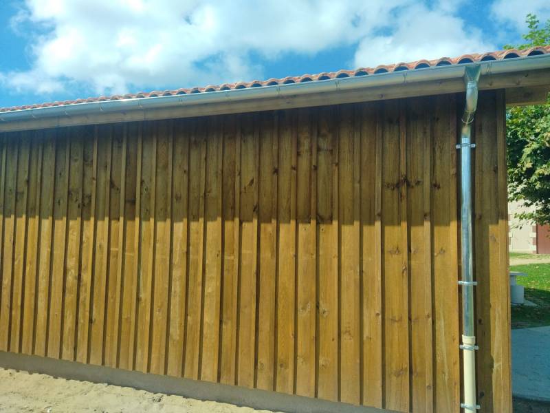 Installer des chéneaux sur une façade située près d’Orx